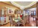 Stately dining area with chandelier, glass table, and hardwood floors provides an elegant setting for dining at 4286 Pacifico Ln, Las Vegas, NV 89135