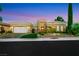 Attractive single-story home featuring well-manicured landscaping, decorative gate, and paved driveway at dusk at 4286 Pacifico Ln, Las Vegas, NV 89135