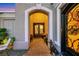 Elegant front porch featuring a decorative door, a seating area, and a bronze statue of a dog at 4286 Pacifico Ln, Las Vegas, NV 89135