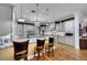 Beautiful kitchen with granite counters, hardwood floors, stainless appliances, and bar seating with views at 4286 Pacifico Ln, Las Vegas, NV 89135