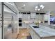 Spacious kitchen showcasing stainless steel appliances, gray cabinetry, granite countertops, and hardwood floors at 4286 Pacifico Ln, Las Vegas, NV 89135