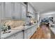 Open concept kitchen featuring granite countertops, custom cabinets, stainless steel appliances, and hardwood floors at 4286 Pacifico Ln, Las Vegas, NV 89135