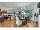 Open concept living room and dining area with hardwood floors and large windows overlooking the backyard at 4286 Pacifico Ln, Las Vegas, NV 89135