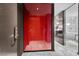 Hallway entrance with unique red closet doors and modern gray flooring at 4381 W Flamingo Rd # 3809, Las Vegas, NV 89103