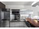 Sleek modern kitchen with stainless steel appliances, a cooktop, and an adjacent breakfast bar at 4381 W Flamingo Rd # 3809, Las Vegas, NV 89103