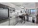 Contemporary kitchenette connects to sitting area with city views and modern appliances at 4381 W Flamingo Rd # 3809, Las Vegas, NV 89103