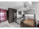 Modern kitchenette with stainless steel appliances and dark wood accents at 4381 W Flamingo Rd # 3809, Las Vegas, NV 89103