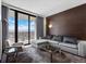 Bright living room with a modern gray sofa, city views, and sliding glass doors to the balcony at 4381 W Flamingo Rd # 3809, Las Vegas, NV 89103