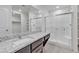 Bathroom features a granite counter, walk-in shower, and white shelving for optimal storage at 4544 Velvet Oak Ct, Las Vegas, NV 89115