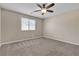 Comfortable bedroom with plush carpet, a ceiling fan, and a large window for natural light at 4544 Velvet Oak Ct, Las Vegas, NV 89115