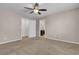 Cozy bedroom with neutral carpet, a ceiling fan, and en-suite bathroom access at 4544 Velvet Oak Ct, Las Vegas, NV 89115