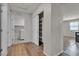 Hallway featuring hardwood floors, a coat closet, and a laundry room with a washing machine at 4544 Velvet Oak Ct, Las Vegas, NV 89115