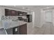 Open kitchen with granite counters, dark cabinets, a stylish backsplash, and modern appliances at 4544 Velvet Oak Ct, Las Vegas, NV 89115