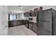 Well-equipped kitchen features dark cabinets, granite countertops, and stainless steel appliances at 4544 Velvet Oak Ct, Las Vegas, NV 89115