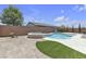 Inviting backyard pool and spa with a surrounding patio, grass and secure brick wall at 4544 Velvet Oak Ct, Las Vegas, NV 89115