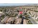 Aerial view of a property in a neighborhood with various amenities surrounded by lush greenery and mountain views at 4562 Sparwood Dr, Las Vegas, NV 89147