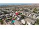 An aerial view of a home and neighborhood that features a swimming pool, luscious landscaping, and mountain views at 4562 Sparwood Dr, Las Vegas, NV 89147