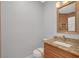 Well lit bathroom featuring a granite countertop and wooden cabinet at 4562 Sparwood Dr, Las Vegas, NV 89147