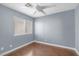 This bedroom features light blue walls, window and a ceiling fan at 4562 Sparwood Dr, Las Vegas, NV 89147