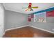 Bedroom featuring a colorful ceiling fan, window, and hardwood floor at 4562 Sparwood Dr, Las Vegas, NV 89147