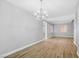 Well-lit dining room with wood-look tile flooring, modern lighting, and neutral paint colors for a serene atmosphere at 4562 Sparwood Dr, Las Vegas, NV 89147