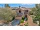 Charming two-story home with a tile roof and a well-manicured front yard in a suburban neighborhood at 4562 Sparwood Dr, Las Vegas, NV 89147