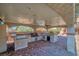 Spacious outdoor kitchen with stainless steel grill, mini refrigerator, and tiled countertops under a covered patio at 4562 Sparwood Dr, Las Vegas, NV 89147