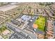 Expansive aerial view of community featuring a school, houses, parking lots, and landscaping at 512 Los Dolces St, Las Vegas, NV 89138