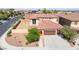 Beautiful two-story home showcasing a well-manicured front yard and a spacious three-car garage at 512 Los Dolces St, Las Vegas, NV 89138