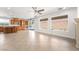 Bright living room combined with a modern kitchen, plenty of windows, and a fireplace at 512 Los Dolces St, Las Vegas, NV 89138