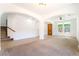 Bright living room highlighting tile flooring, neutral paint, archways and two windows for natural light at 512 Los Dolces St, Las Vegas, NV 89138