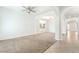 Bright living room showcasing neutral paint, carpeted floors and elegant archways to other rooms at 512 Los Dolces St, Las Vegas, NV 89138