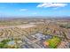 An aerial view captures a Primary-planned community with tree-lined streets and diverse housing options at 512 Los Dolces St, Las Vegas, NV 89138