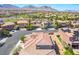 Scenic aerial view of the neighborhood with desert landscaping and mountain views in the distance at 512 Los Dolces St, Las Vegas, NV 89138