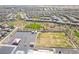 Aerial view of a Primary-planned community with parks, schools and desert landscaping at 512 Los Dolces St, Las Vegas, NV 89138