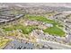 An overhead shot of a vibrant community park features walking paths, grassy hills, and trees at 512 Los Dolces St, Las Vegas, NV 89138