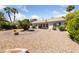 Expansive backyard featuring desert landscaping, palm trees, and ample space for outdoor activities at 5232 Saranac Rd, Las Vegas, NV 89130
