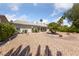 Large backyard offering desert landscaping with palm trees for relaxing and entertaining at 5232 Saranac Rd, Las Vegas, NV 89130