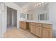 Bathroom featuring a dual sink vanity with a large mirror at 5232 Saranac Rd, Las Vegas, NV 89130