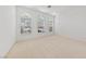 Bright and airy bedroom featuring three large windows and neutral carpeting at 5232 Saranac Rd, Las Vegas, NV 89130