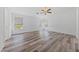 Bedroom with wood-look flooring, ceiling fan, and window with blinds at 5232 Saranac Rd, Las Vegas, NV 89130