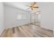 Bedroom with wood-look flooring, ceiling fan, and sliding closet door at 5232 Saranac Rd, Las Vegas, NV 89130