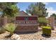 Entrance to North Bristol featuring a stone monument sign, landscaping, and wrought iron fencing at 5232 Saranac Rd, Las Vegas, NV 89130