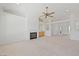 Open-concept living room with a fireplace, built-in bar, and neutral decor, creating a bright and airy space at 5232 Saranac Rd, Las Vegas, NV 89130