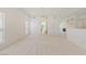 Bright living room with chandelier, neutral carpet, and views into the kitchen and other living spaces at 5232 Saranac Rd, Las Vegas, NV 89130