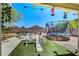 Covered backyard featuring a patio, play area, trampoline, and beautiful desert landscaping at 5236 Krista Alethea St, North Las Vegas, NV 89031