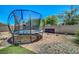 Backyard featuring a trampoline, desert landscaping, and block wall for privacy at 5236 Krista Alethea St, North Las Vegas, NV 89031