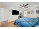 Bright bedroom featuring a ceiling fan, wood flooring, and modern decor at 5236 Krista Alethea St, North Las Vegas, NV 89031