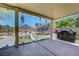 Relaxing covered patio features a trampoline, slide, barbeque, and desert landscape at 5236 Krista Alethea St, North Las Vegas, NV 89031