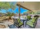 Covered patio with an outdoor seating area, desert landscaping, and a view of the backyard at 5236 Krista Alethea St, North Las Vegas, NV 89031
